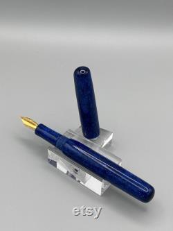 A unique handcrafted bespoke Fountain Pen. The body of the pen is made of resin with blues, a touch of black and has sparkle to it