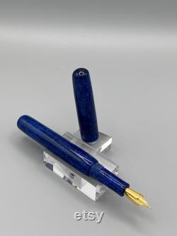 A unique handcrafted bespoke Fountain Pen. The body of the pen is made of resin with blues, a touch of black and has sparkle to it